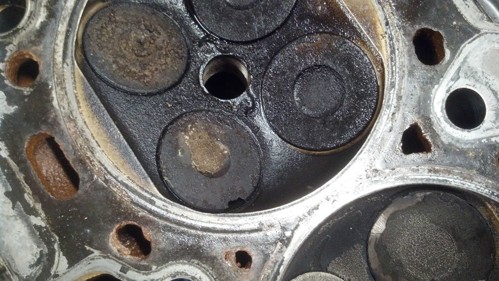 Z16XEP cylinder were the gasket had been leaking oil and with chipped exhaust valve
